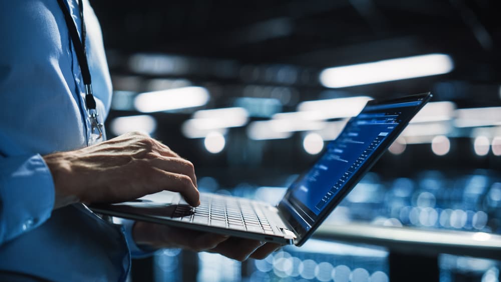 programmer using a laptop with codes